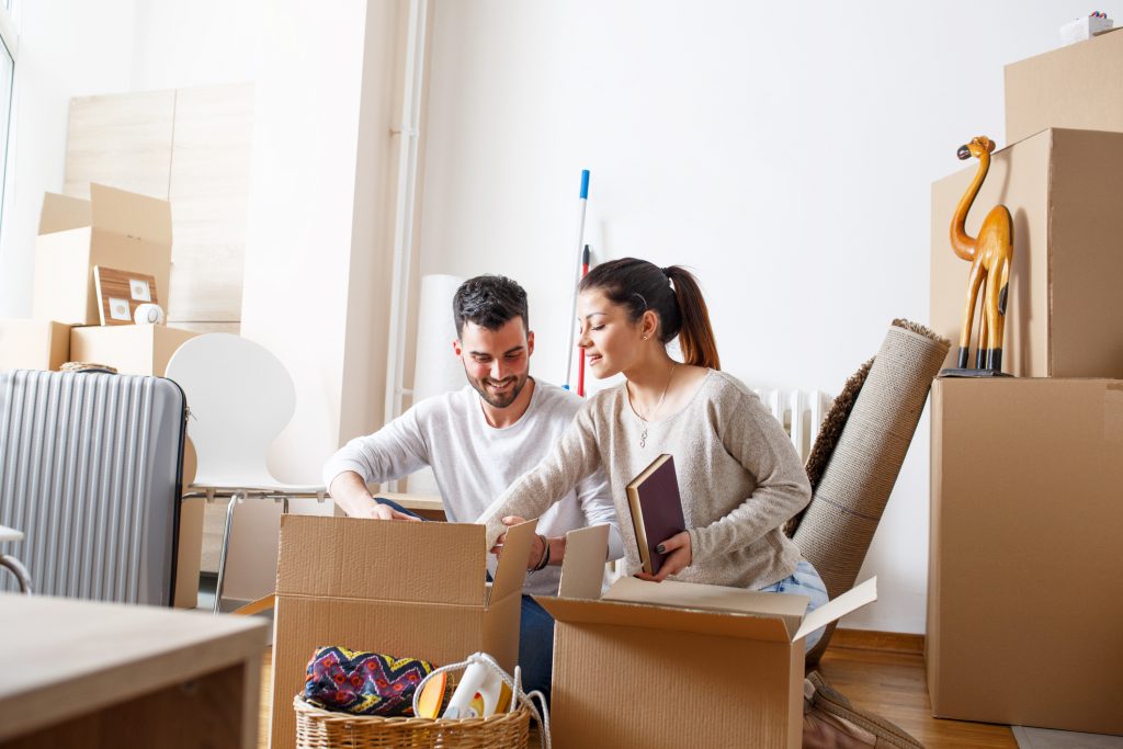 Couple unpacking moving boxes