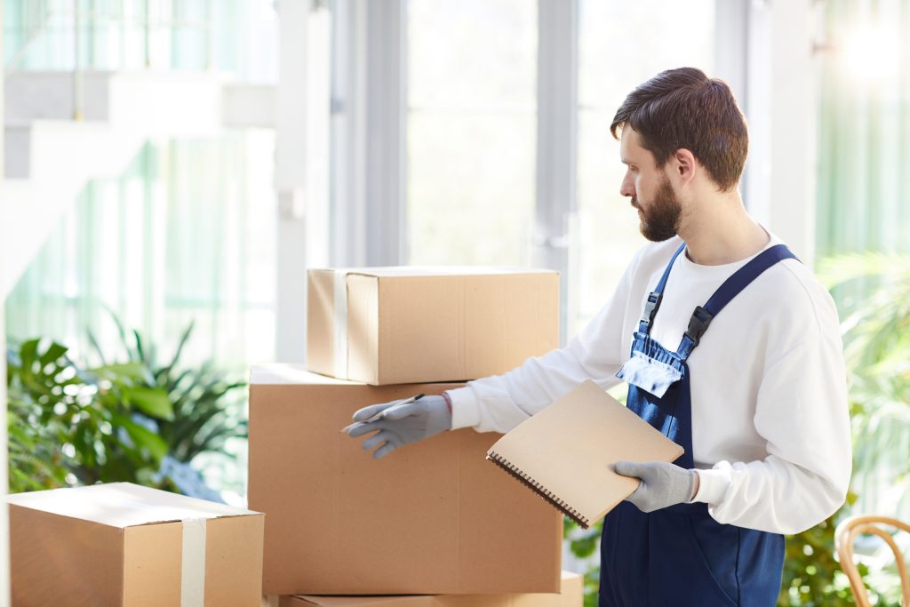 moving manager inspecting moving boxes