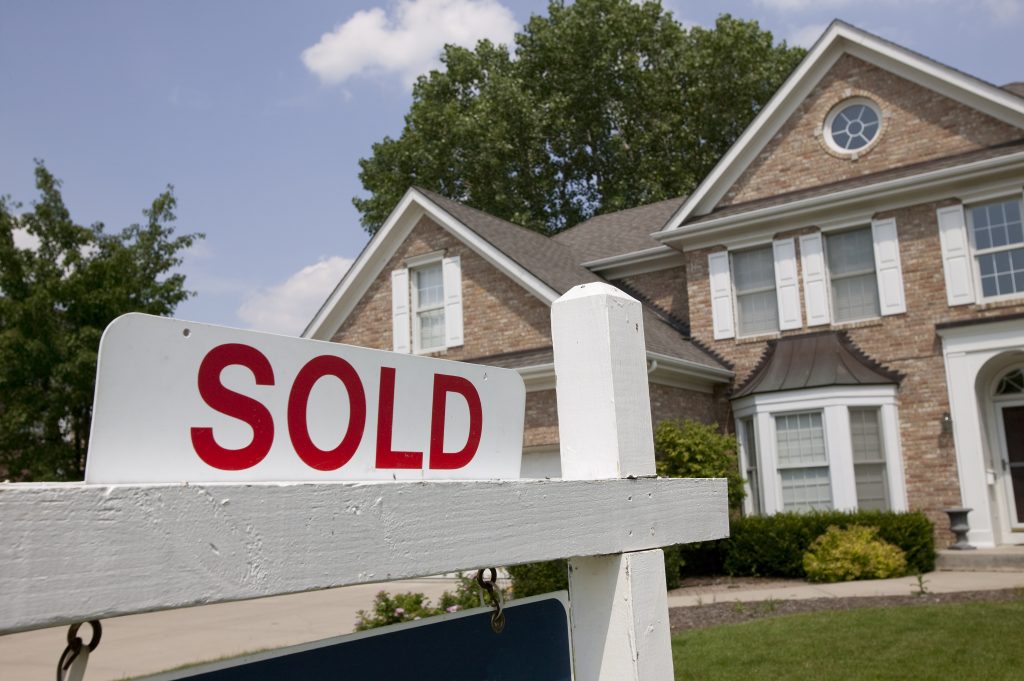 sold sign in front of house