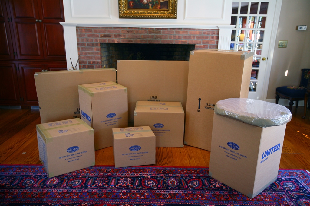 Meyer moving boxes in a variety of sizes in front of a fireplace