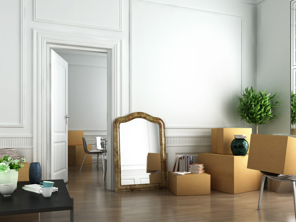 Moving boxes, mirror, and furniture on a house.