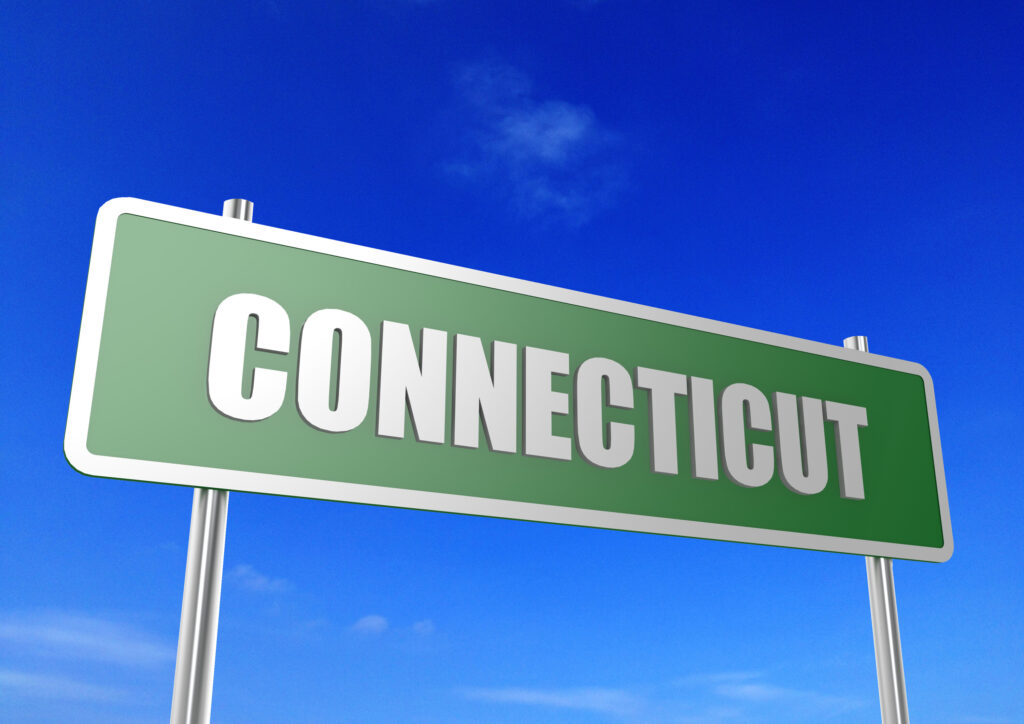 Green street sign with "Connecticut" in white letters.