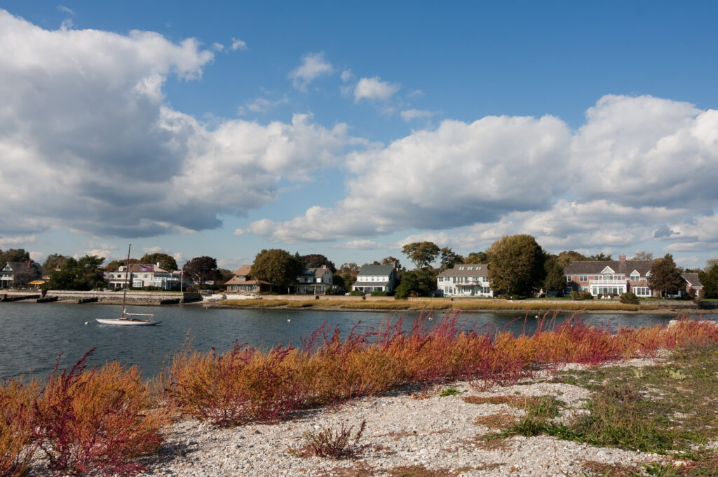 Picturesque homes in Connecticut with water in the forground.