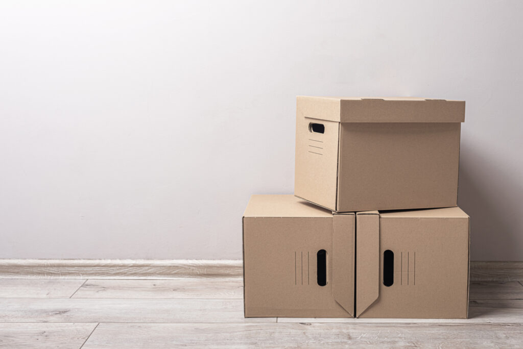 moving boxes stacked up in empty room.